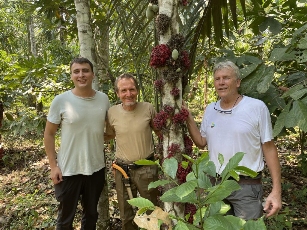 Johannes Milz, Ernst Götsch and Joachim Milz beside a Theobroma speciosum tree on the family farm in Alto Beni, Bolivia