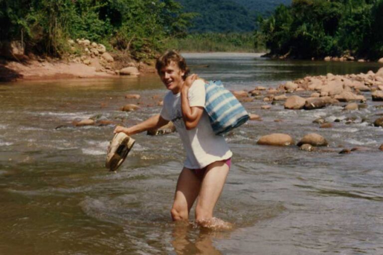 Joachim Milz wading through a river in Bolivia in 1987, during Joseph Wilhelm’s search for organic cocoa
