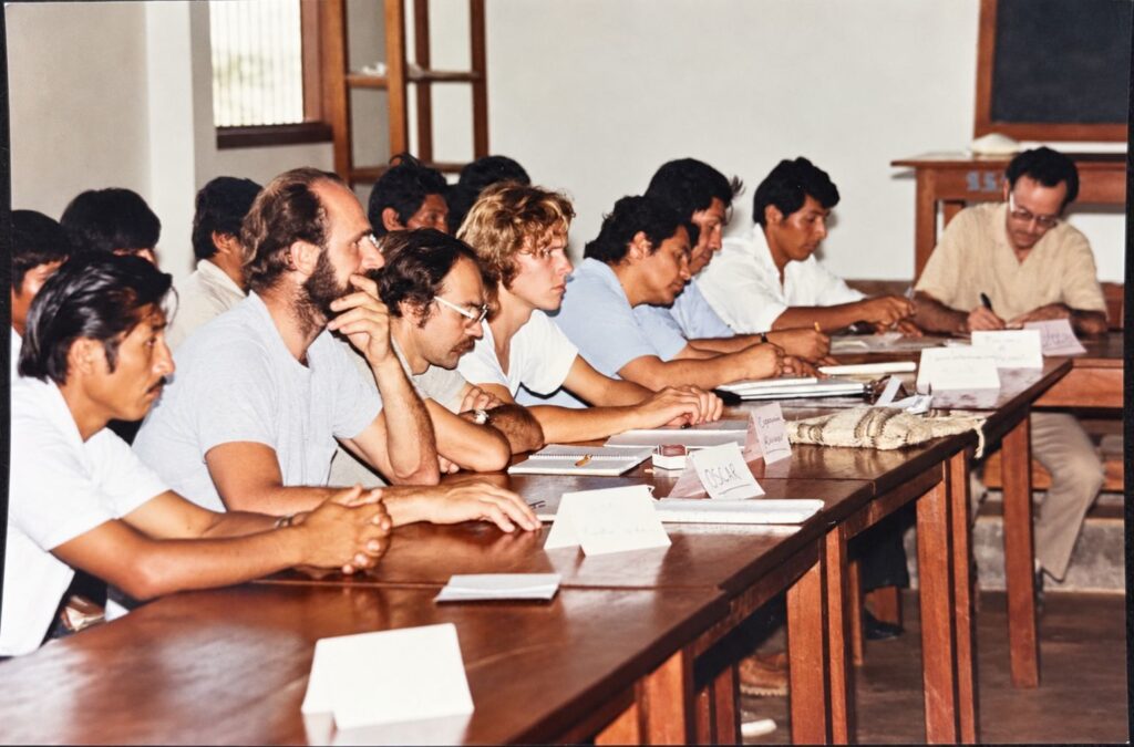 Meeting in Alto Beni, Bolivia, in the early 1990s, participants seated at long tables, among them Padre Roberto Eckerstorfer, Bernardo Ebenberger and Joachim Milz